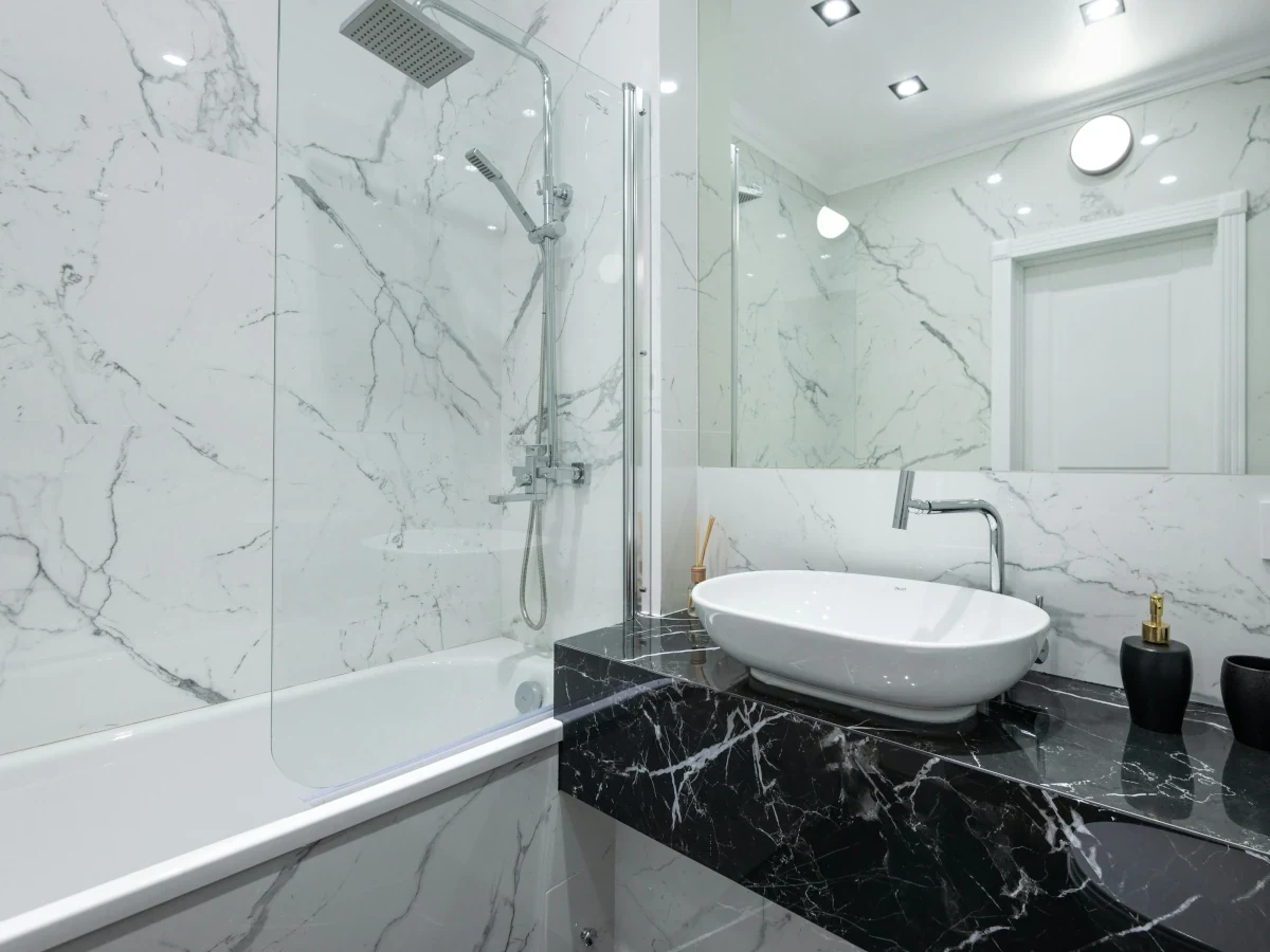 Minimalist shower with large grey tiles installed by Daffodil Tiling, Swansea