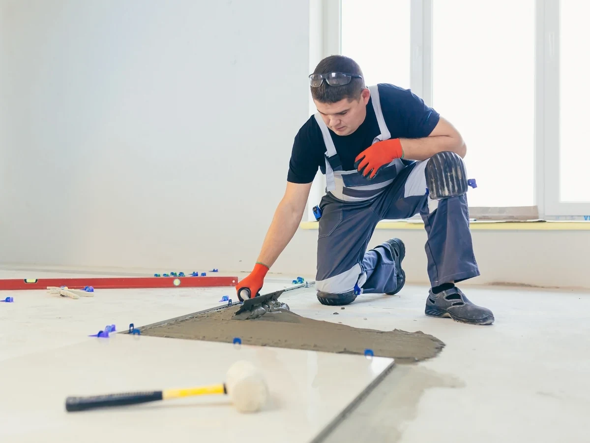 Expert tiler carrying out floor tile installation in Swansea, Daffodil Tiling