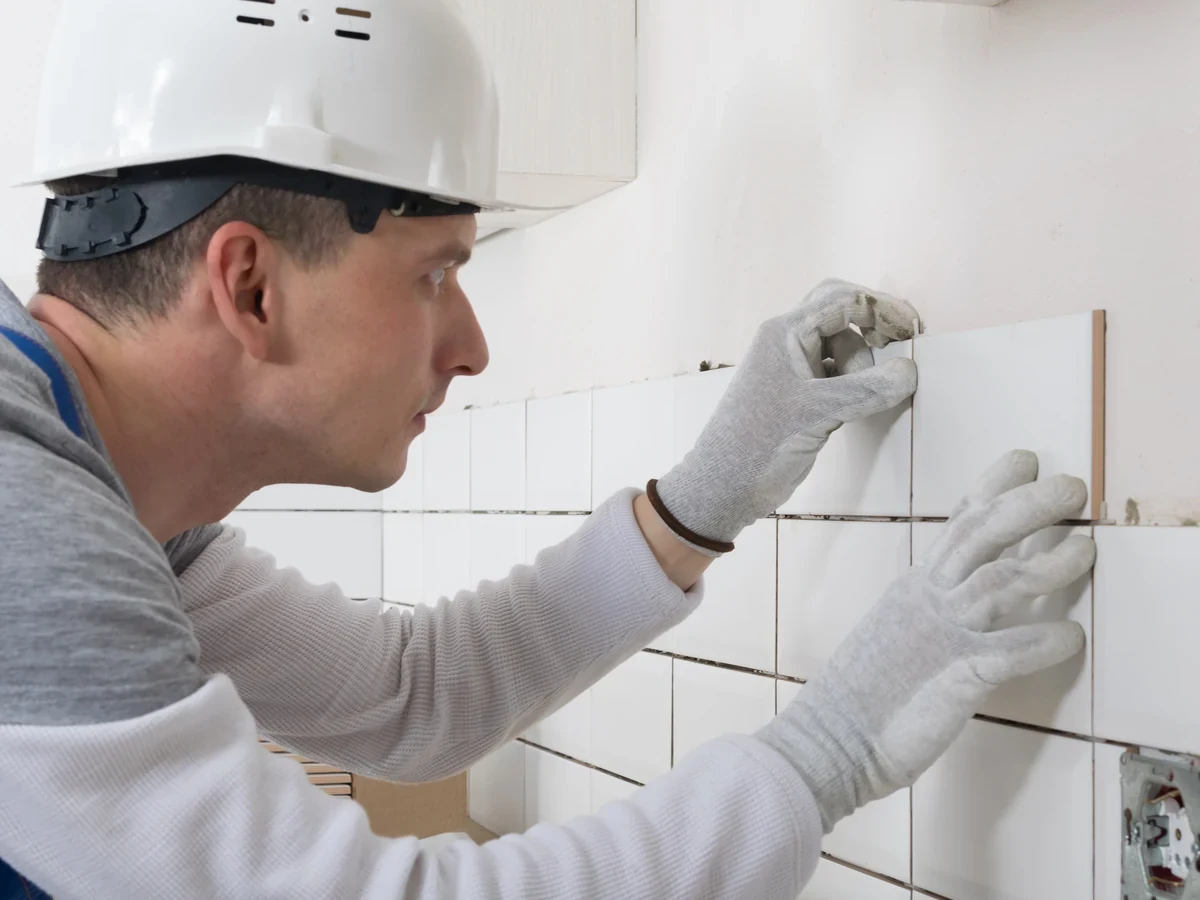 Professional tiler applying tiles on site, Daffodil Tiling Swansea