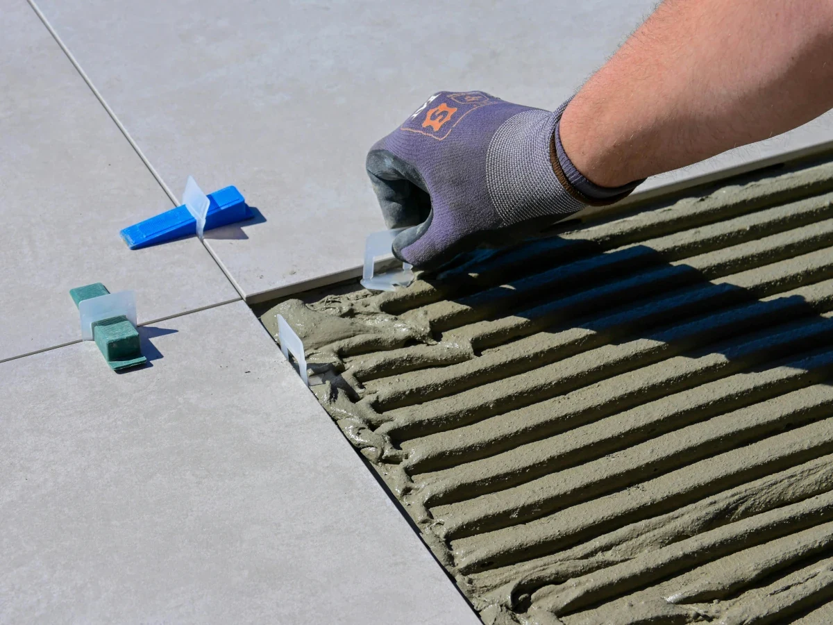 Tile levelling system in use during floor installation by Daffodil Tiling, Swansea